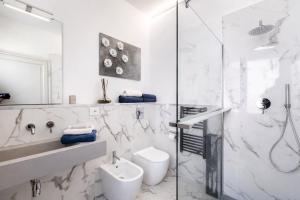 a bathroom with a shower and a toilet and a sink at Villa Miranda Luxury Como Lake View Penthouse with Panoramic Terrace in Como +65 photos