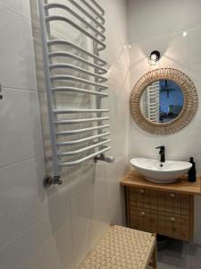 a bathroom with a sink and a mirror at Apartament Fajny Kąt in Ustrzyki Dolne +36 photos