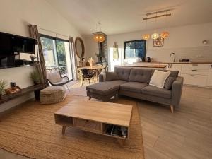 a living room with a couch and a table at Domaine Hestia in Robion en Luberon