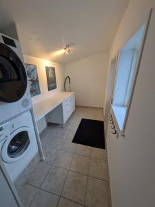 a laundry room with a washer and a washing machine at Hus 5 personer in Hjørring +4 photos