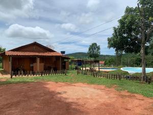 a small house with a swimming pool in front of it at Recanto do Vale in Pirenópolis