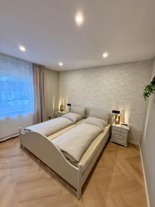 a large bed in a bedroom with a large window at Ferienwohnung Luna in Eppelborn