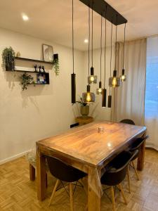 a dining room with a wooden table and chairs at Ferienwohnung Luna in Eppelborn +16 photos
