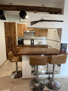 a kitchen with a wooden counter and some bar stools at Location 6 personnes patrimonio in Patrimonio