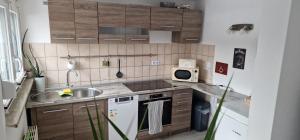 a small kitchen with a sink and a microwave at Bartol in Immendingen