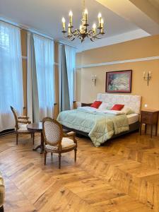 a bedroom with a bed and a table and chairs at Experiencebruges in Bruges