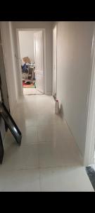 an empty room with a white floor and a door at Canarya compound in 6th Of October