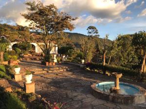 a garden with a fountain in the middle of a yard at Hotel Puntalarga PGB in Nobsa