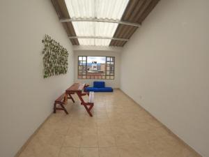 a room with a table and a bench in it at Bacata Housing full in Bogotá
