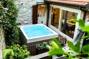 a hot tub on the deck of a house at Il borghetto di Torno in Torno