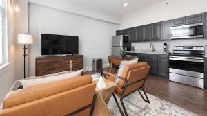 a kitchen and living room with a couch and chairs at Landing Amazing Studio Gym in Spartanburg