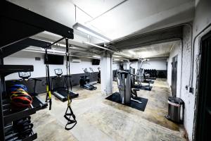 a gym with treadmills and machines in a room at Landing Amazing Studio Gym in Spartanburg