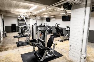 a gym with several treadmills and cardio machines at Landing Amazing Studio Gym in Spartanburg +8 photos