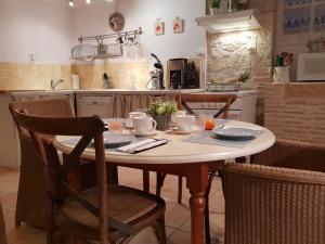 a kitchen with a table with dishes on it at Prouyssou in Beauville +1 photo