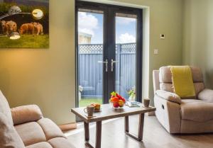 a living room with a chair and a coffee table at Pentarow Barn in Falmouth