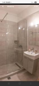 a bathroom with a shower and a sink at Lithaia Aura-Trikala in Pýrgos