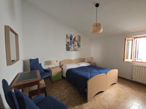 a bedroom with a bed and a table and chairs at La Dimora Di Pienza in Pienza