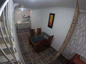 a dining room with a glass table and chairs at Bacata Housing full in Bogotá