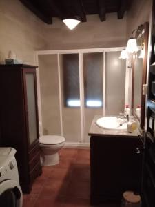 a bathroom with a toilet and a sink and a toilet istg at Los Tres Lobitos in Orgaz +21 photos