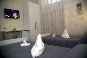 Habitación con 2 camas y almohadas blancas. en Le Torri Aragonesi, en Nápoles