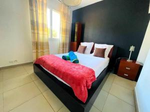 a bedroom with a large bed with a red blanket at Vila paradise in Ollioules