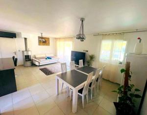 a dining room and living room with a table and chairs at Vila paradise in Ollioules