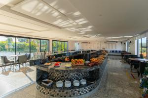 a hotel lobby with a breakfast buffet in the center at Villa Santorini Boutique & Hotel in Pirenópolis