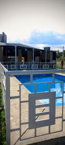 a swimming pool in front of a building at Los Adobes in Cerrillos