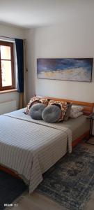 a bed with pillows on it in a bedroom at Garsonka u pivovaru, centrum Rožnov in Rožnov pod Radhoštěm