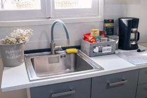 a kitchen counter with a sink in a kitchen at Lithaia Aura-Trikala in Pýrgos +9 photos