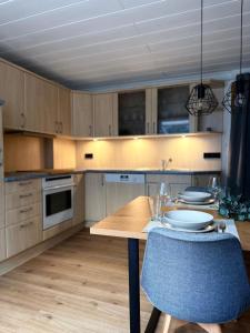 a kitchen with a wooden table and a blue chair at Apartment 18 in Kurort Oberwiesenthal