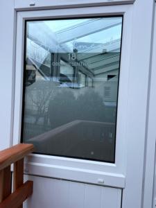 a window in a door with a reflection in it at Apartment 18 in Kurort Oberwiesenthal