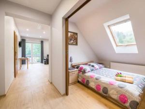 a bedroom with a bed in a room with a window at Pod Stokiem in Lubomierz