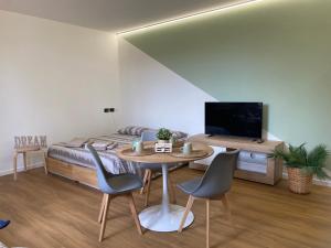 a bedroom with a bed and a table and chairs at La casetta al parco in Ponte San Nicolo