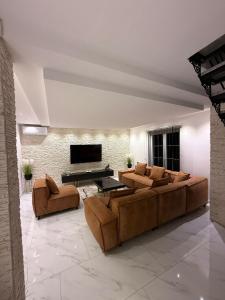 a large living room with couches and a television at Villa Leah in Bihać