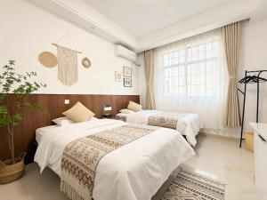 a hotel room with two beds and a window at Damao Holiday shanghai pvg 24hFREE shuttle bus in Shanghai