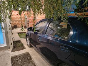 a blue car parked in front of a house at Bajo el Sauce in Ranchos +9 photos