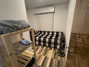 a small room with two bunk beds in it at Bajo el Sauce in Ranchos
