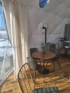 a table and chairs in a room with a window at Glamping Liptov in Liptovský Trnovec