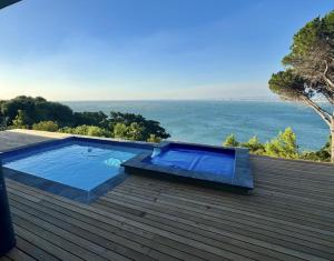 a swimming pool on the roof of a house at Oceana Views in Gordonʼs Bay