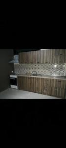 a kitchen with wooden walls and a counter top at Villa Bakuriani hotel in Bakuriani