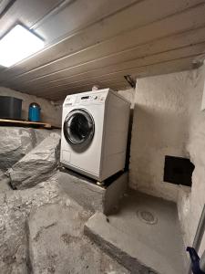 a washer and dryer sitting in a garage at Cozy apartment in quiet neighborhood in Oslo