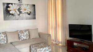 a living room with a couch and a flat screen tv at Opal Heights in Gampaha