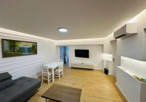 a living room with a couch and a table at Lapi Guest House Korca in Korçë