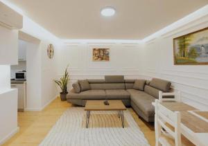 a living room with a couch and a table at Lapi Guest House Korca in Korçë