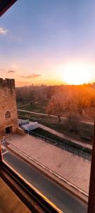a view of a sunset from a window at Mirador del Torreón in Alcañiz