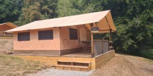a building with a tent on top of a field at Tente lodge la perche in Le Lonzac +26 photos