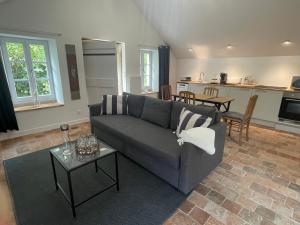 a living room with a couch and a table at Gîte des Templiers in Couches