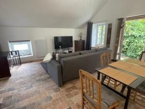 a living room with a couch and a table at Gîte des Templiers in Couches