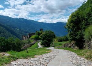 a road leading to a castle in the mountains at Bella Vista casa vacanze in Grosio +9 photos